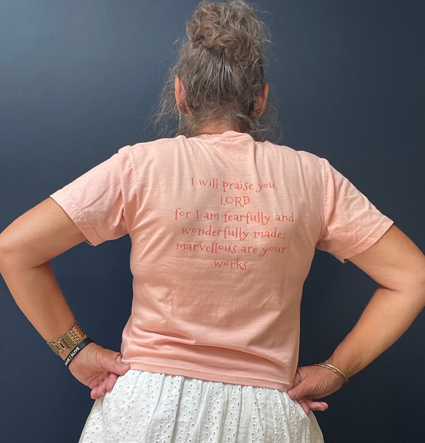 Model in Peachy with Psalm 139:14 printed on the back, wearing size Small